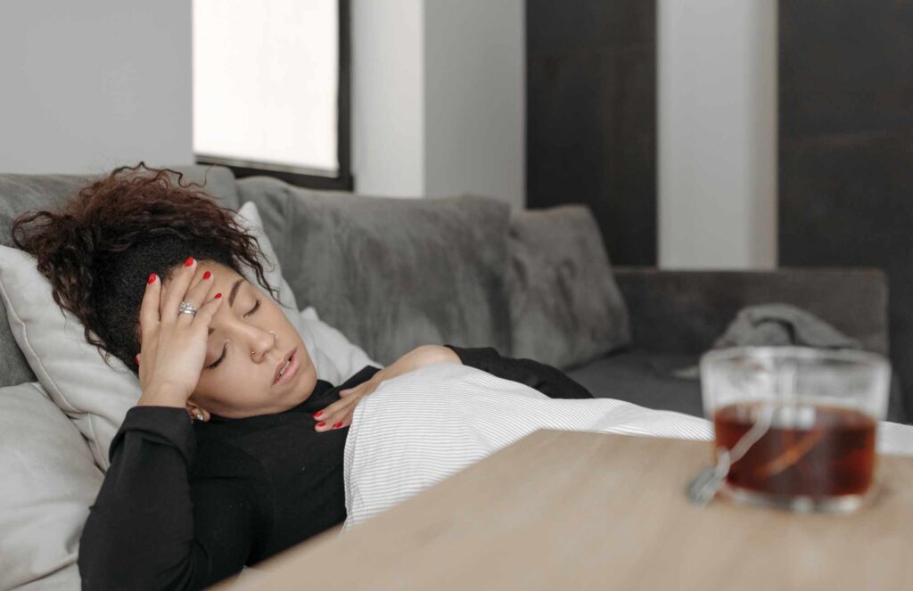 A woman suffering from being sick in need of the immunity IV drip