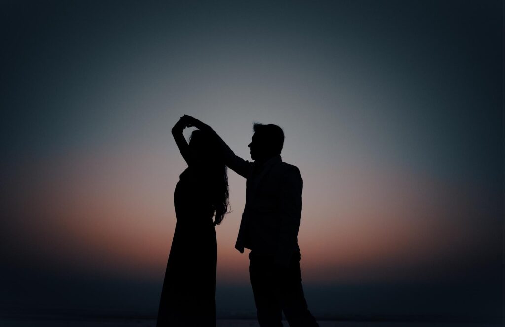Silhouette of a couple dancing at sunset, representing the confidence and peace of mind that comes with regular HCG.