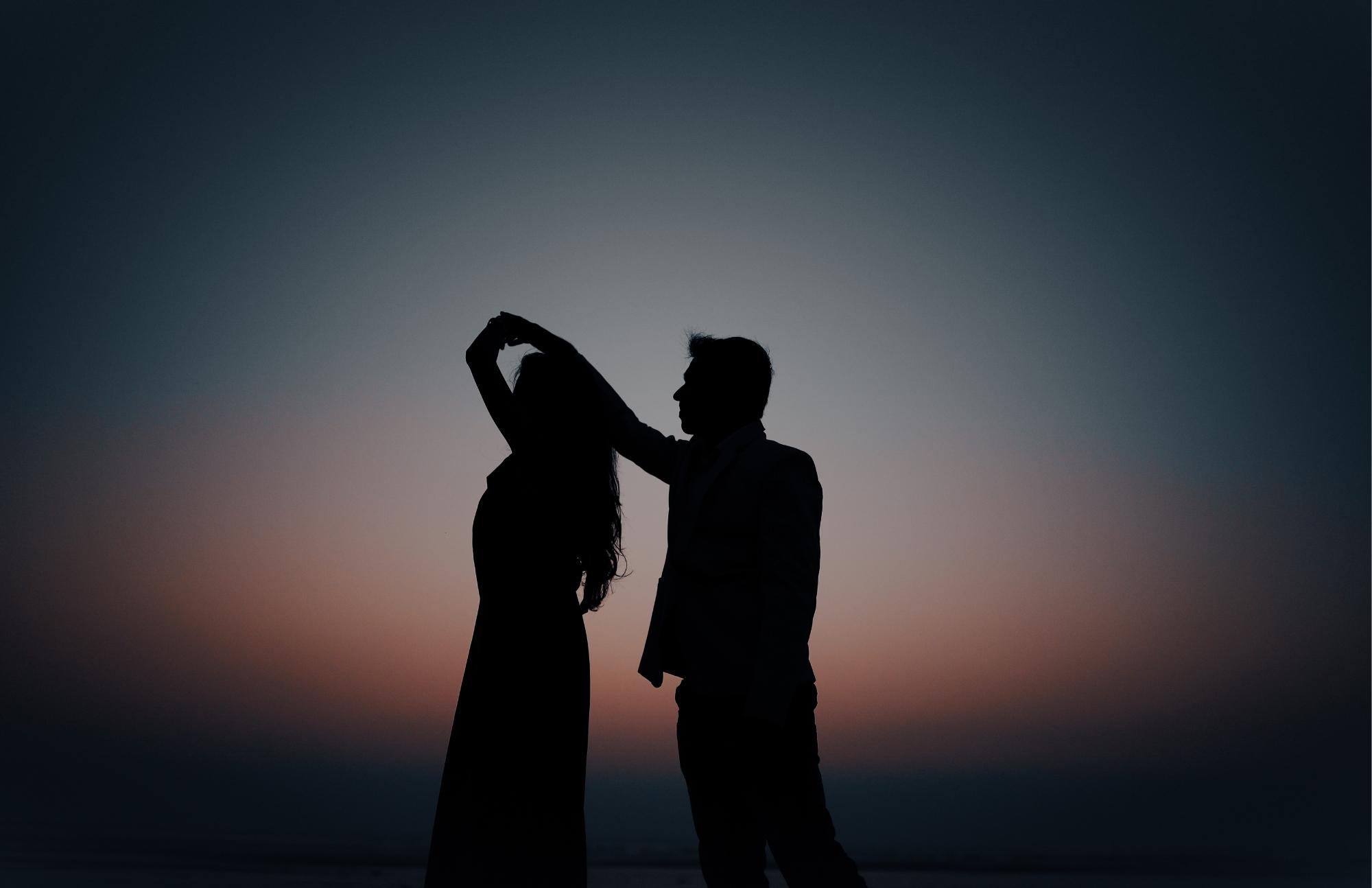 Silhouette of a couple dancing at sunset, representing the confidence and peace of mind that comes with regular STD screening.