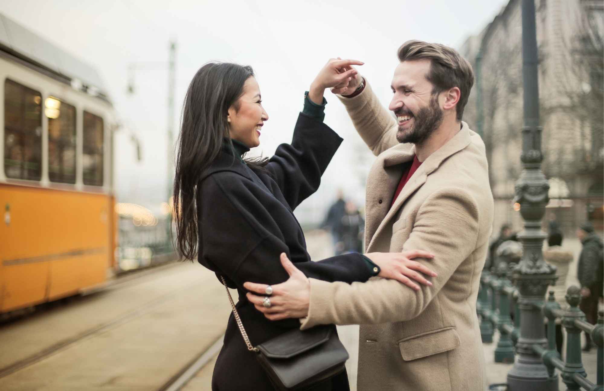 A joyful couple dancing in the street, symbolizing the energy and vitality that Vitamin B12 provides for daily well-being.