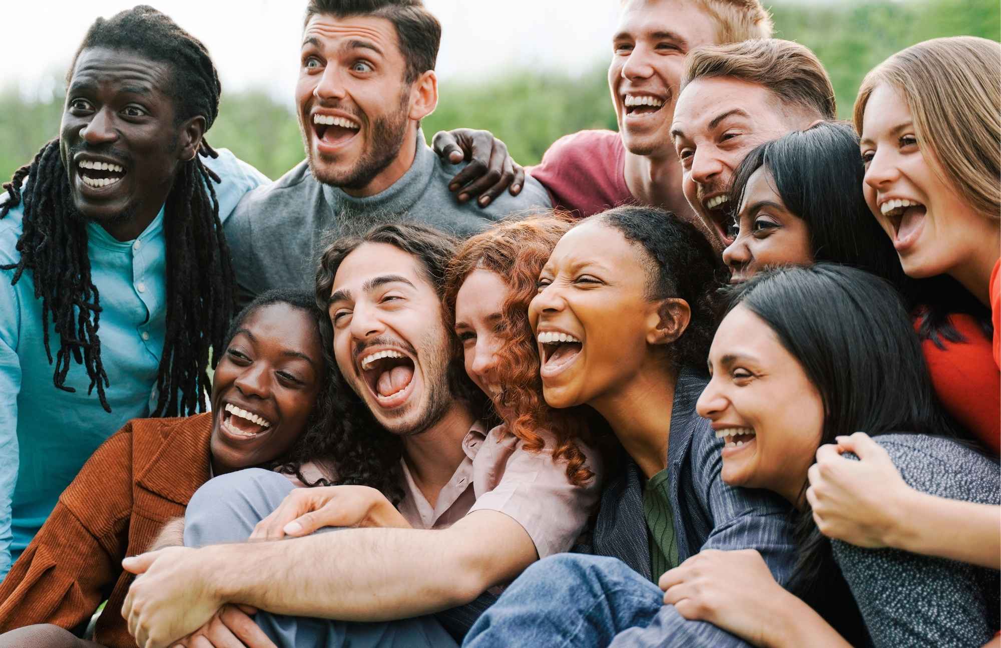 A diverse group of people smiling and laughing together, symbolizing increased energy and vitality from B12 injections.