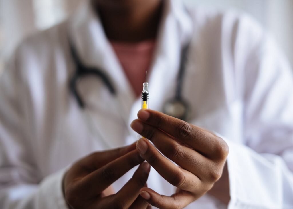 A doctor getting ready to inject a patient