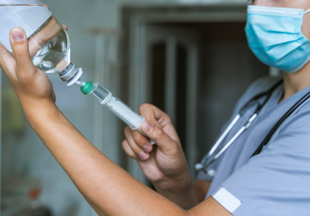 A nurse injecting the IV Drip Bag