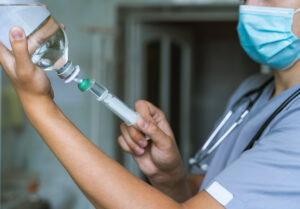 A nurse injecting the IV Drip Bag