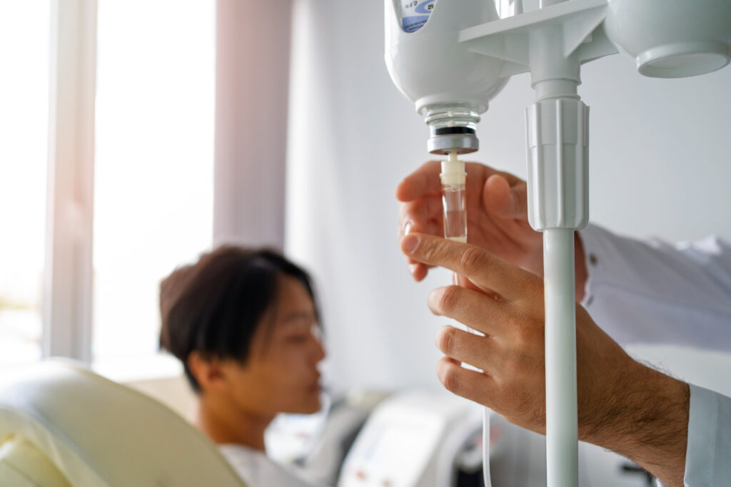 The nurse adjusting the speed of IV drip