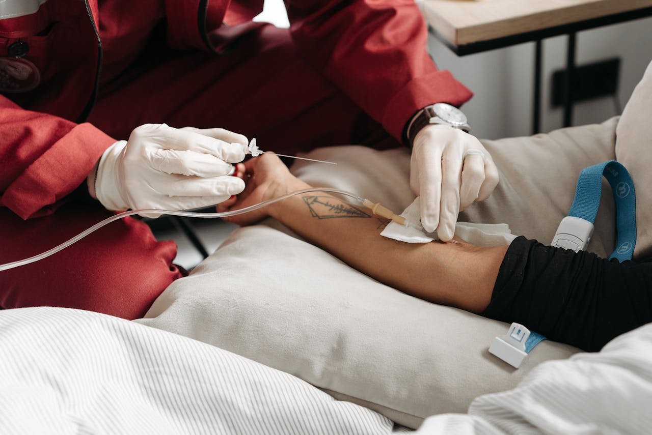A nurse giving IV drip to the patient