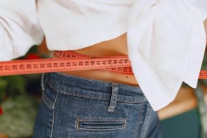 A girl checking her waist after losing weight
