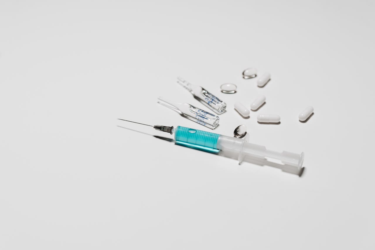 injection and tablets on a white surface